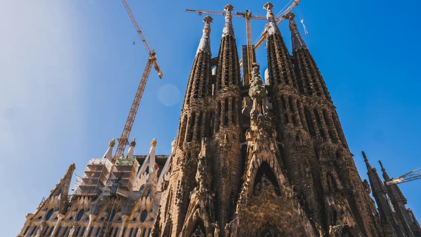 The soaring, intricate spires of the Sagrada Família under a clear blue sky.